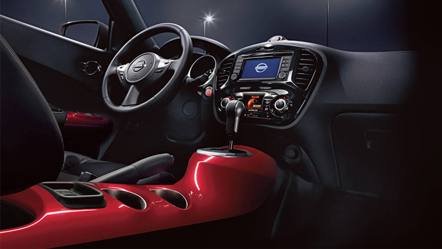 2017 Nissan JUKE interior, highlighting the red center console